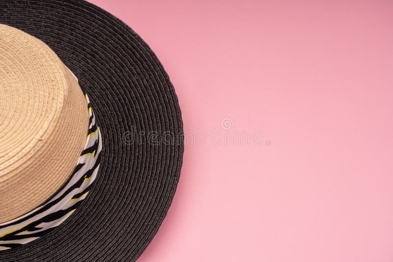 Half of a Beach Straw Hat for Sun Protection on a Pink Background