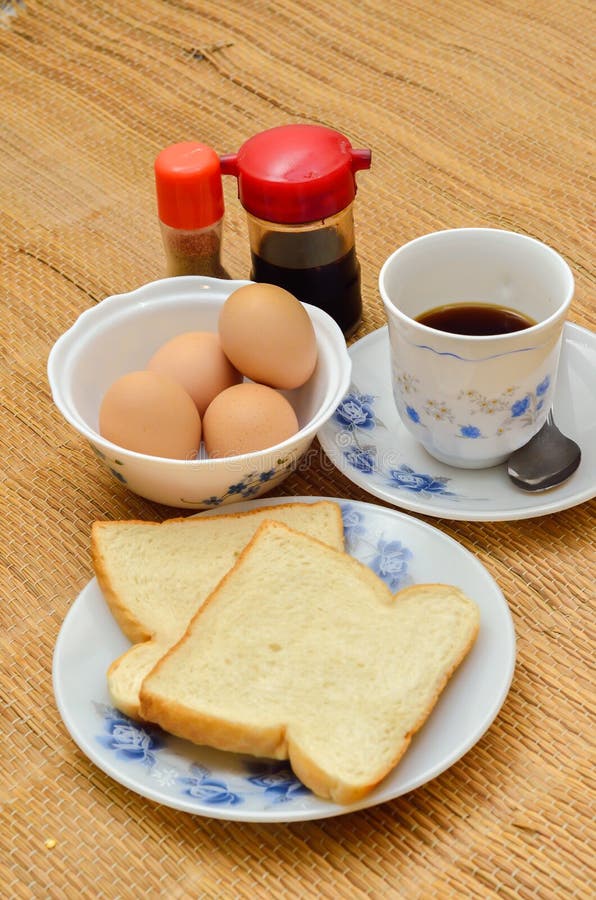 Halfboiled Eggs with Soy Sauce and Coffee and Breads Stock Photo