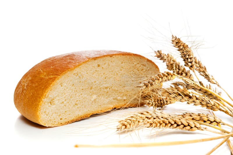 Half of bread loaf and wheat spikes, isolated