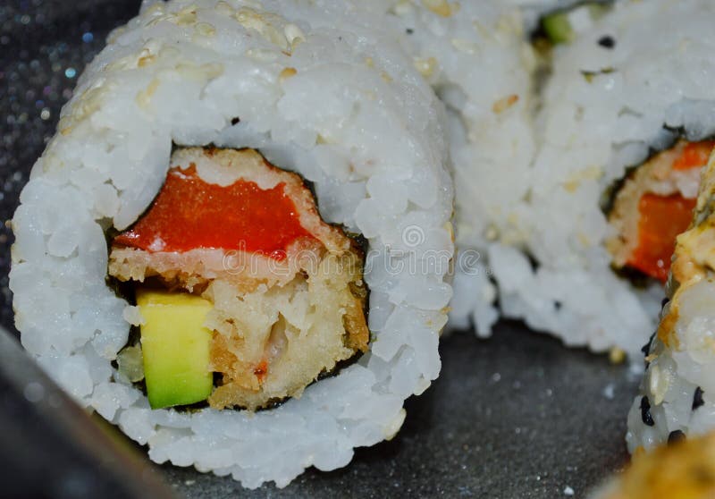 Half Crab Sushi Roll Stuffed with Avocado and Cream Cheese Stock Image