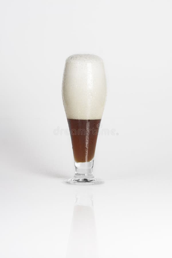 Half of glass of cold dark beer royalty free stock photography