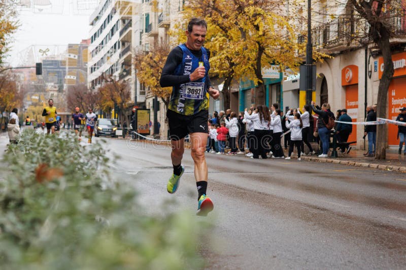 Half marathon runner passing through Camilo Sesto Avenue in Alcoy royalty free stock photos