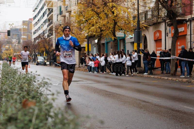 Half marathon runner passing through Camilo Sesto Avenue in Alcoy stock image