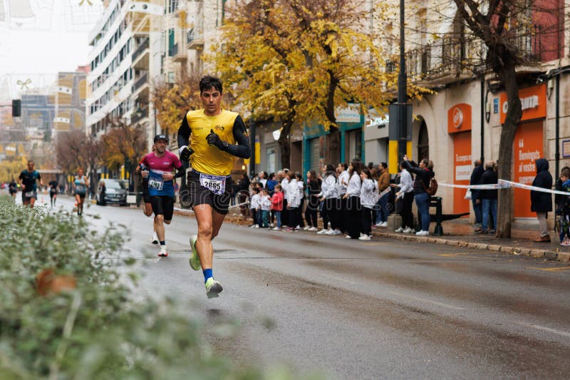Half marathon runner passing through Camilo Sesto Avenue in Alcoy royalty free stock photos
