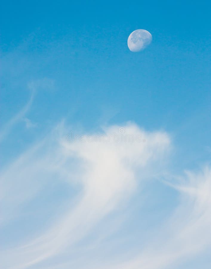 A half moon riding in the sky above wispy cirrus clouds stock photos A half moon riding in the sky above wispy cirrus clouds stock photos
