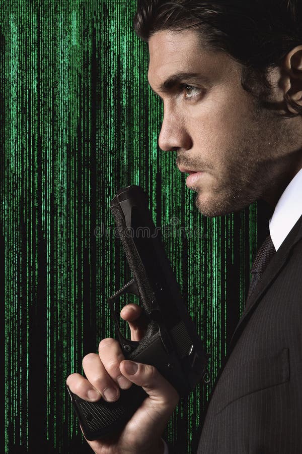 Half portrait of a seductive cyber spy with gun in hand. Studio shot with matrix background