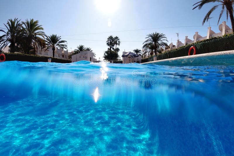 Half shot empty underwater split photography blue water of swimming pool