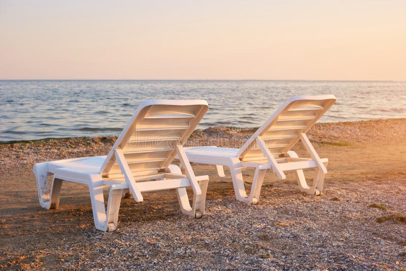 Halfturn View Chaise Longues on the Beach. Stock Photo Image of