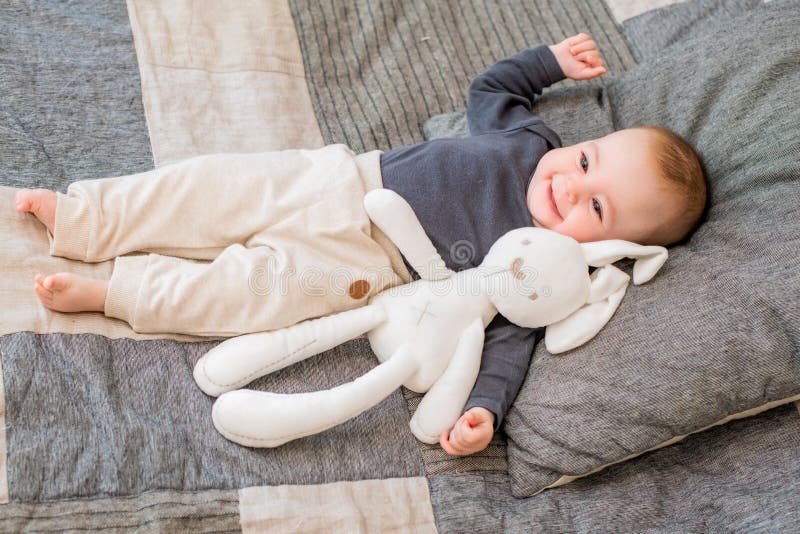 Halfyearold Baby Lies on the Bed Smiling Stock Photo Image of young, teething 193481526