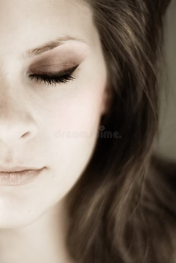 Half young womans face with eyes closed