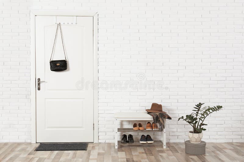 Hall interior with brick wall and white door