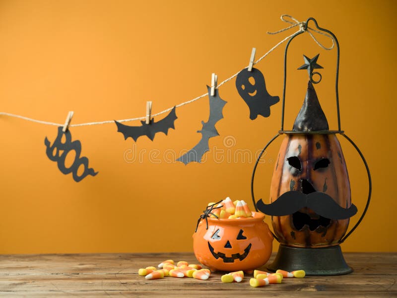 Halloween background with decor jack o lantern and candy corn on wooden table