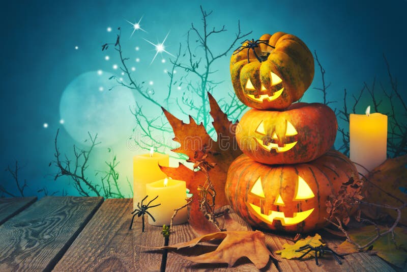 Halloween background with pumpkin jack o lantern on wooden table