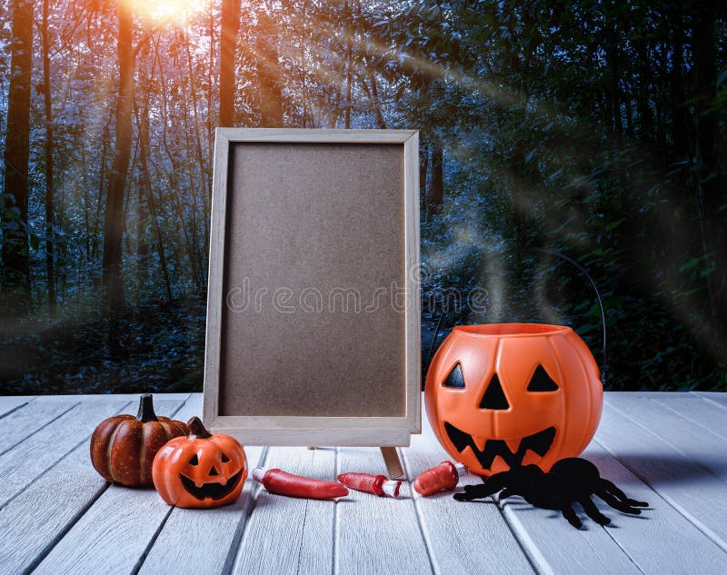 Halloween background. Spooky pumpkin, chalkboard on wooden floor royalty free stock image Halloween background. Spooky pumpkin, chalkboard on wooden floor royalty free stock image