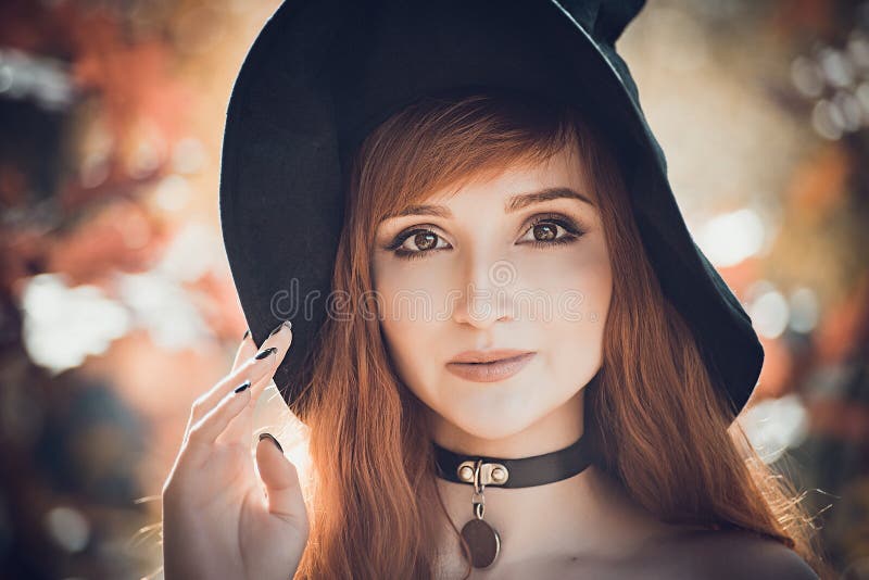 Halloween Beautiful young Witch girl in witches hat