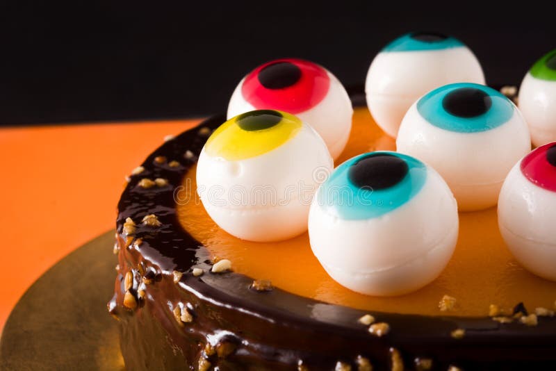 Halloween Cake with Candy Eyes Decoration on Orange and Black Background.  Stock Image - Image of kids, holiday: 155507013