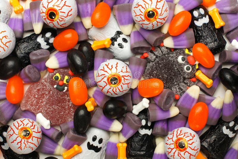 Halloween background of mixed candies, dark color theme. Halloween background of mixed candies, dark color theme