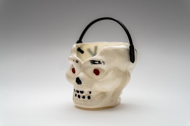 Halloween Candy Bucket in Form of Skull on a Gray Background Stock