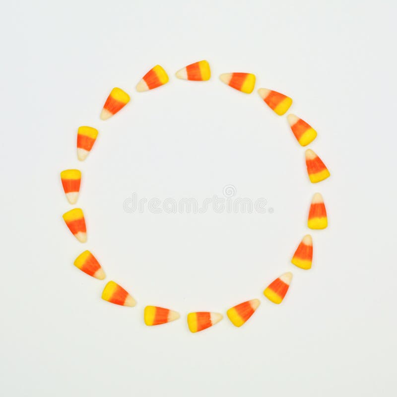 Halloween candy corn circle frame on a white background with copy space