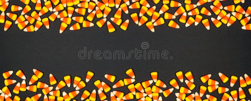 Halloween candy corn double border banner. Top view on a black background with copy space. Halloween candy corn double border banner. Top view on a black background with copy space
