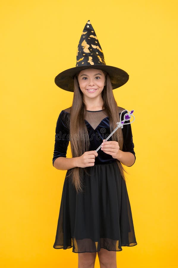 Halloween child in witch hat hold magic wand for witchery, happy halloween stock photos