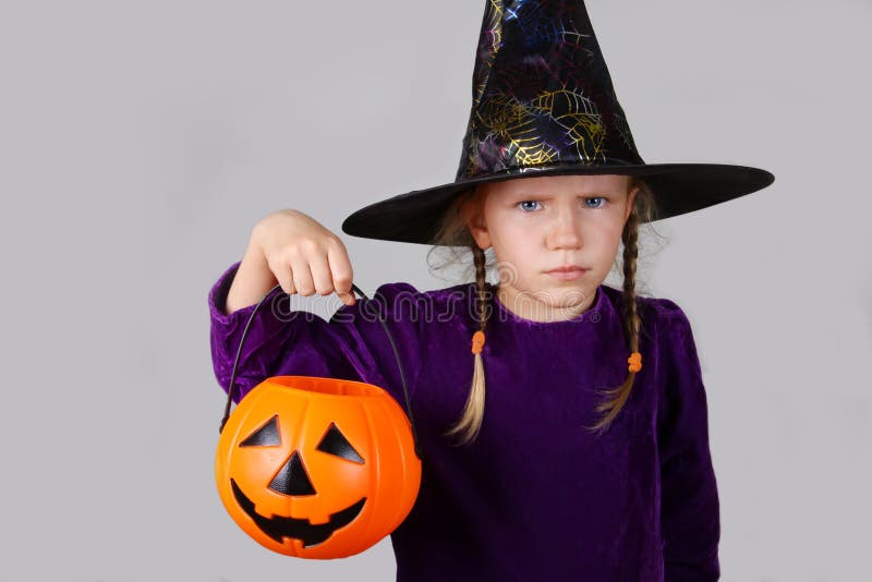 Halloween Concept. Beautiful child girl in witch costume with with pumpkin Jack. royalty free stock photography Halloween Concept. Beautiful child girl in witch costume with with pumpkin Jack. royalty free stock photography