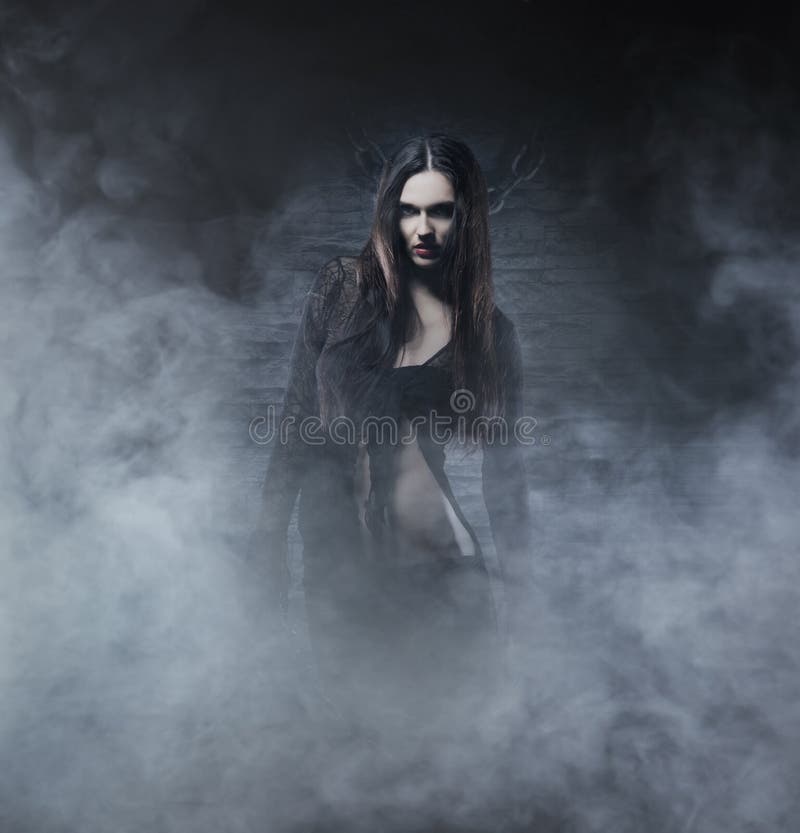 Halloween concept: young and witch royalty free stock photography