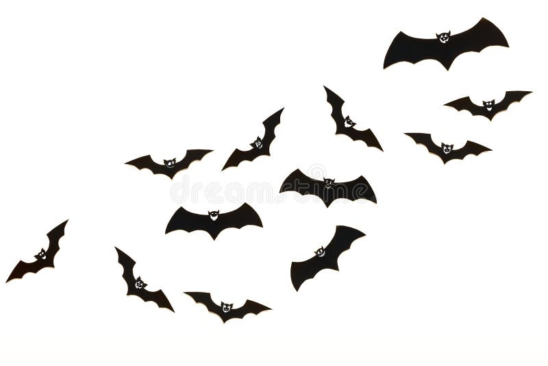 Halloween and decoration concept. Cute smiling black paper bats flying over white background.
