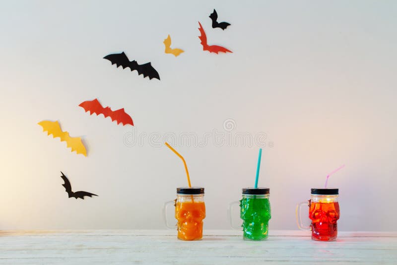 Halloween decorations with drinks in mug in form of skull stock photo Halloween decorations with drinks in mug in form of skull stock photo