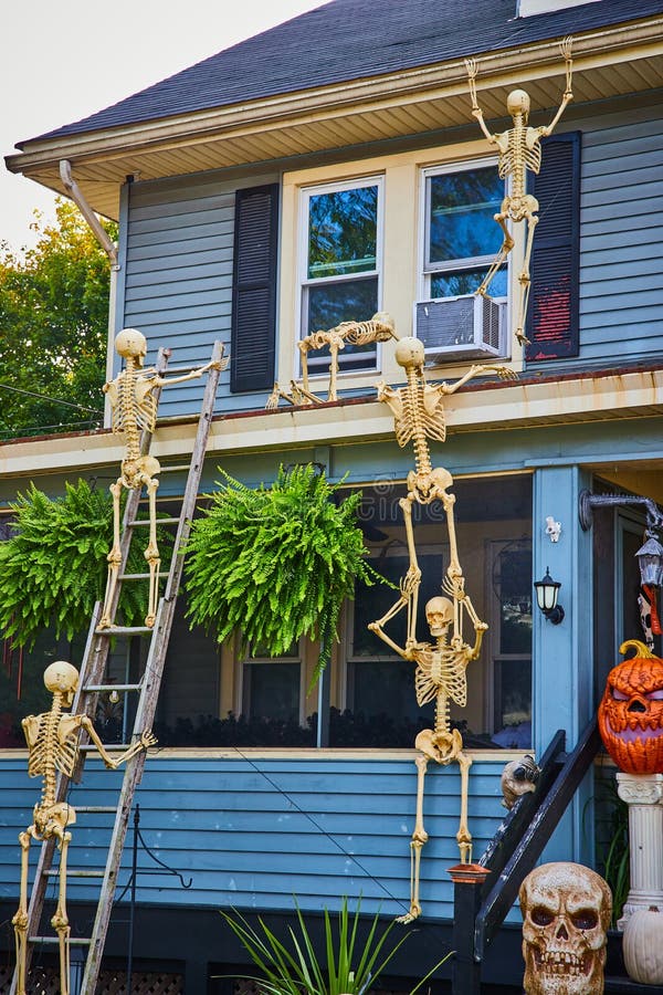 Halloween Decorations on Exterior of Home with Skeletons Climbing Up To ...