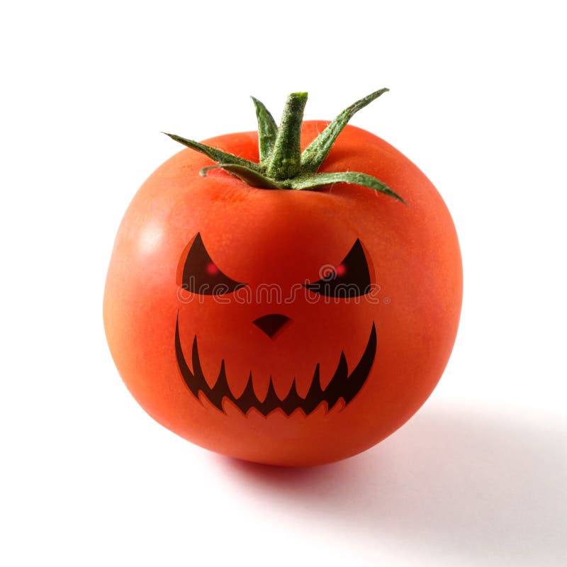 Halloween face on the fresh tomato on white background.