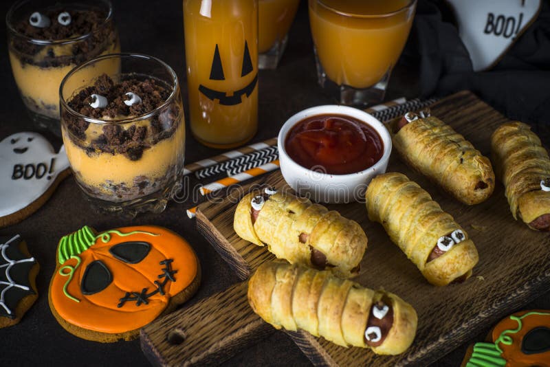 Halloween food assortment - sasage mummies, pumpkin dessert, gin royalty free stock photo Halloween food assortment - sasage mummies, pumpkin dessert, gin royalty free stock photo