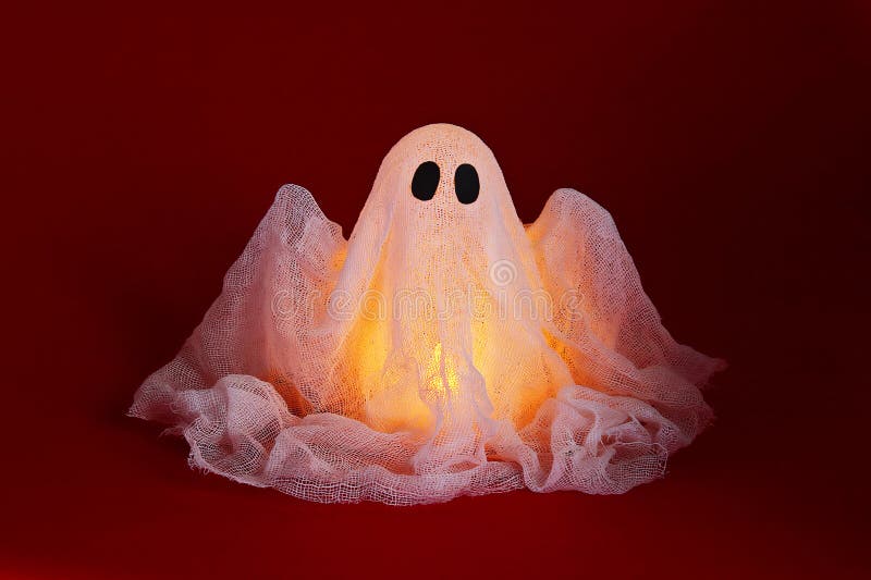 Halloween ghost of starch and gauze on orange background. Gift idea, decor Halloween stock photos Halloween ghost of starch and gauze on orange background. Gift idea, decor Halloween stock photos
