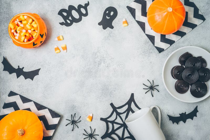 Halloween holiday background with pumpkin and candy corn. Top view from above. Flat lay