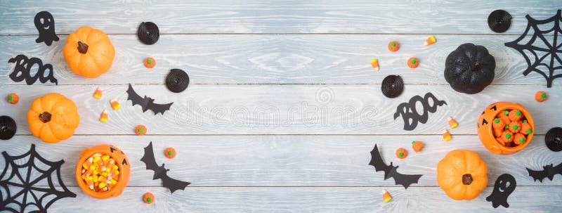 Halloween holiday party background with glitter pumpkin decor and candy. Top view from above. Flat lay