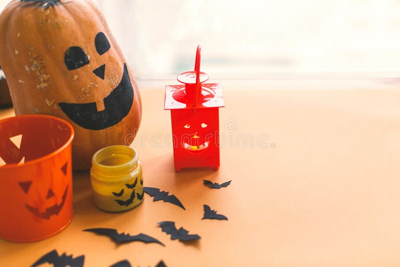Halloween jack o lantern, pumpkin, candle, black bats and ghost paper decorations on yellow background.Trick or treat concept. stock photography Halloween jack o lantern, pumpkin, candle, black bats and ghost paper decorations on yellow background.Trick or treat concept. stock photography