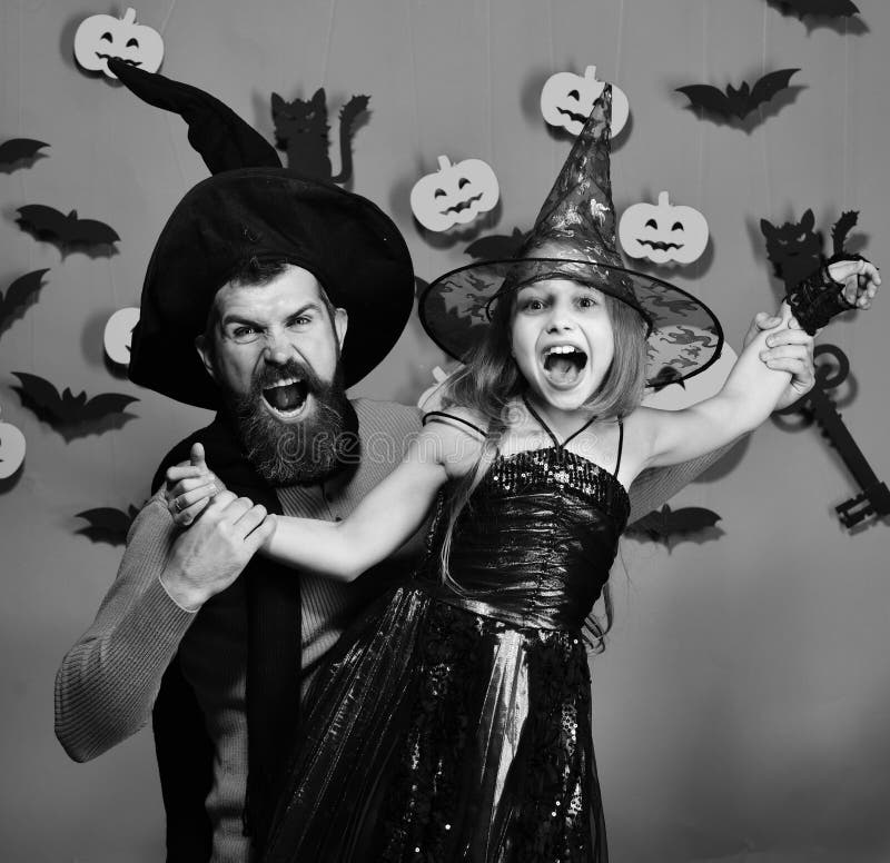 Halloween party concept. Wizard and little witch in black hats royalty free stock photography Halloween party concept. Wizard and little witch in black hats royalty free stock photography