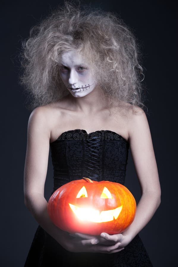 Halloween portrait of ghost with orange pumpkin