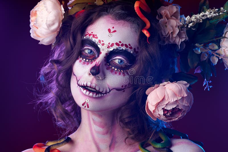 Halloween make up sugar skull beautiful model. Santa Muerte concept. Flower snakes Halloween. Halloween make up sugar skull beautiful model. Santa Muerte concept. Flower snakes Halloween