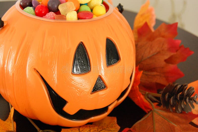 A halloween pumpkin filled with candy from trick or treating. A halloween pumpkin filled with candy from trick or treating.
