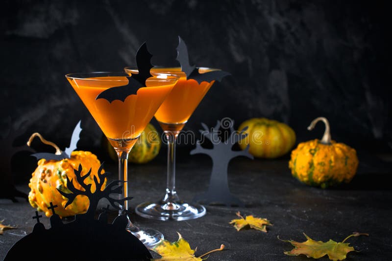 Halloween pumpkin cocktail. Food Concept, glasses with  black bats and holiday decorations on dark background