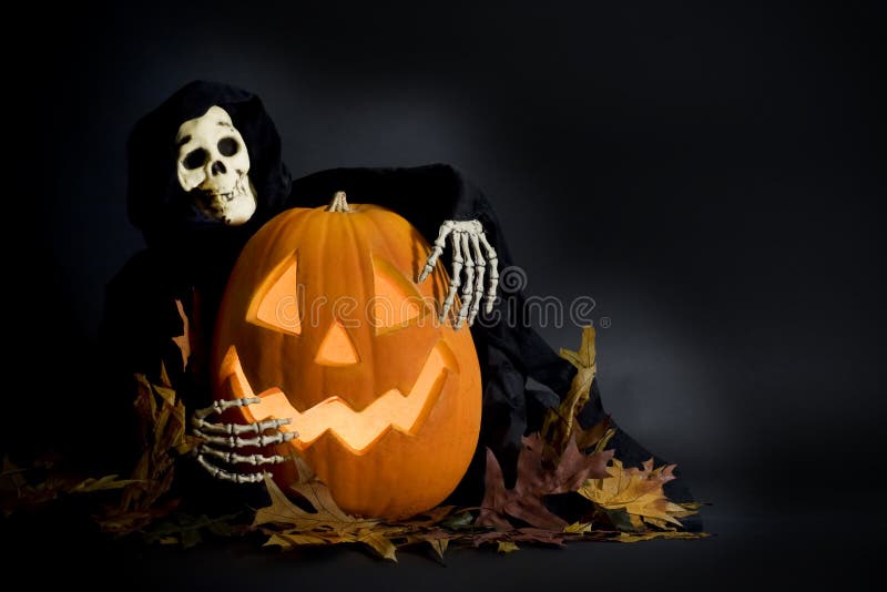 A smiling Halloween pumpkin being hugged by a ghostly ghoul, and fall leaves scattered on black background. A smiling Halloween pumpkin being hugged by a ghostly ghoul, and fall leaves scattered on black background