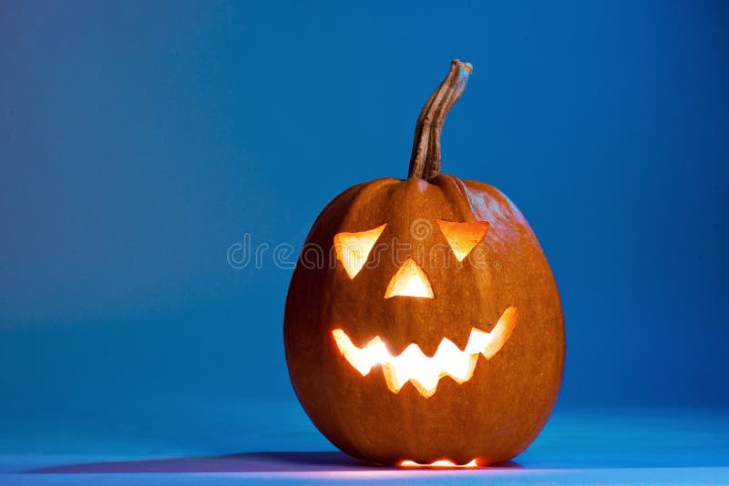 Halloween pumpkin, silhouette of funny face on blue background. royalty free stock photos Halloween pumpkin, silhouette of funny face on blue background. royalty free stock photos