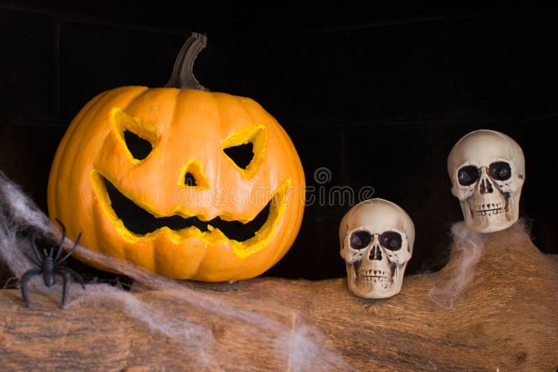 Halloween pumpkin and skull in a fireplace stock images Halloween pumpkin and skull in a fireplace stock images