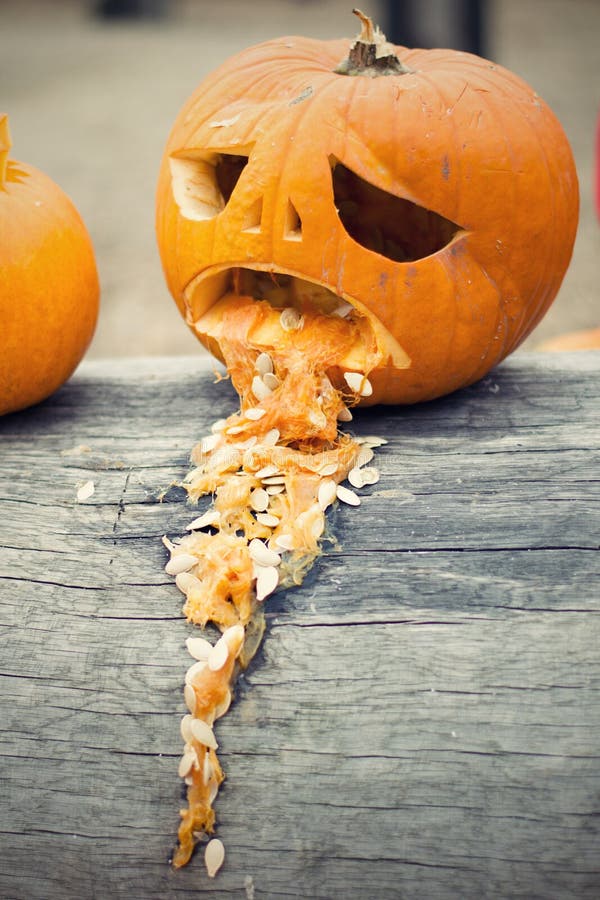 halloween-pumpkin-vomit-throw-up-tree-trunk-photo-sad-96191305.jpg