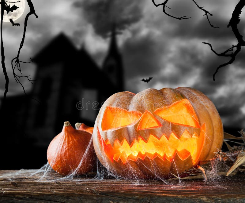 Concept of halloween pumpkin on wooden planks. Blur scary castle on background. Concept of halloween pumpkin on wooden planks. Blur scary castle on background