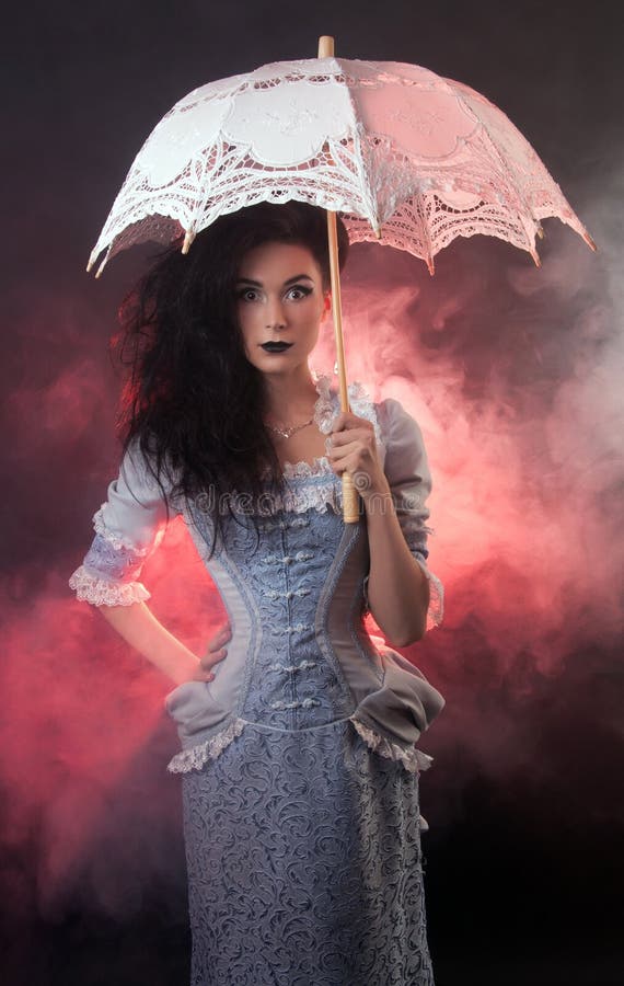 Halloween vampire woman with lace-parasol