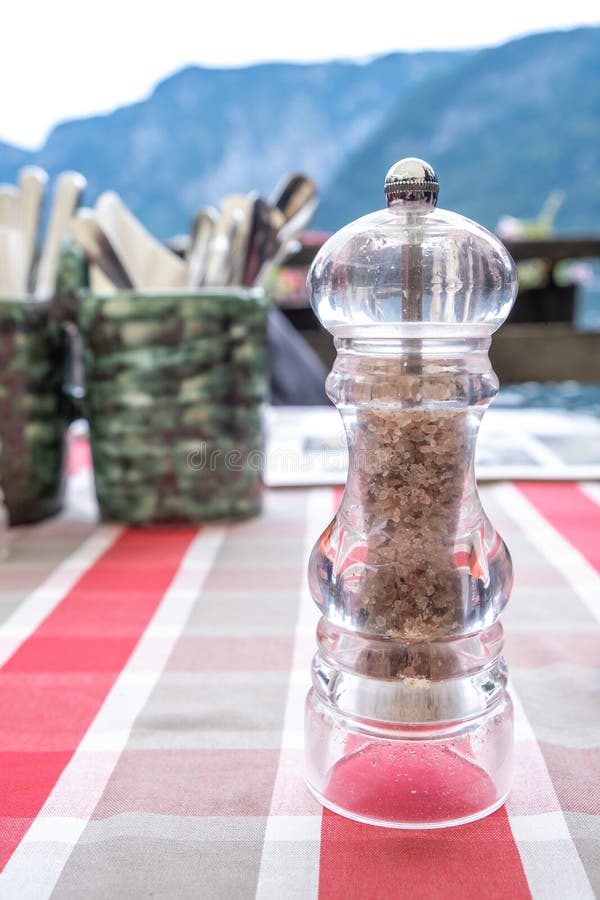 Hallstatt local Salt Shaker on the table at a romantic restaurant beside the Hallstatter See Lake in High Alps Mountains, a