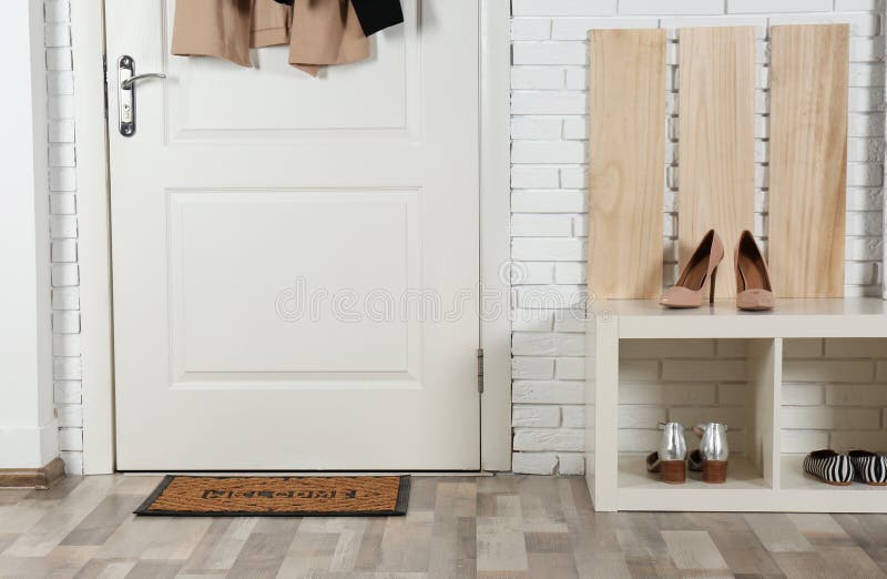 Hallway interior with shoe rack and mat