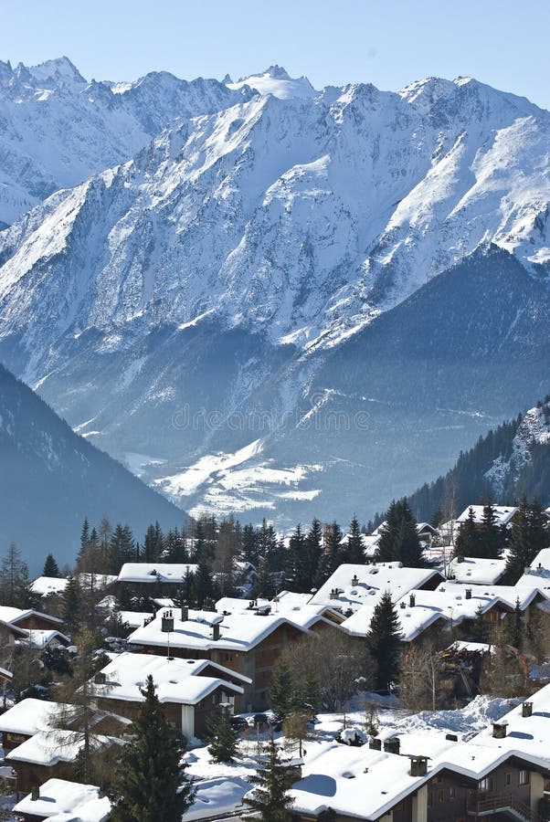 View of verbier in the swiss alps on perfect crisp winters day, perspective compression from extreme telephoto lens. View of verbier in the swiss alps on perfect crisp winters day, perspective compression from extreme telephoto lens